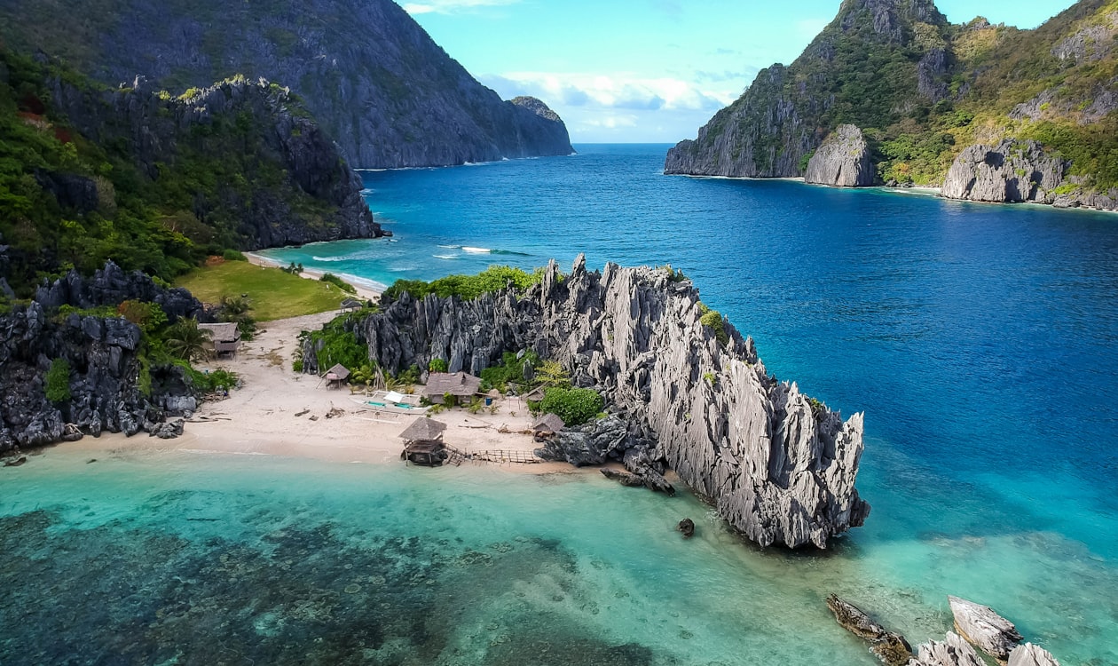 Crystal clear turquoise waters and limestone cliffs at a Philippine beach destination