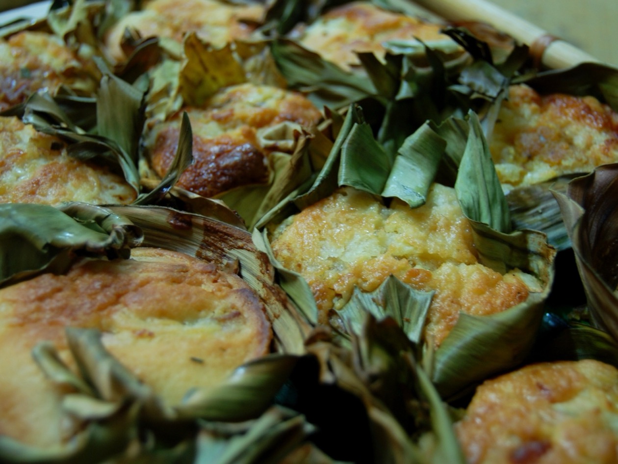 Bibingka galapong (Filipino rice cake) baked in banana leaf cups, golden brown and freshly made