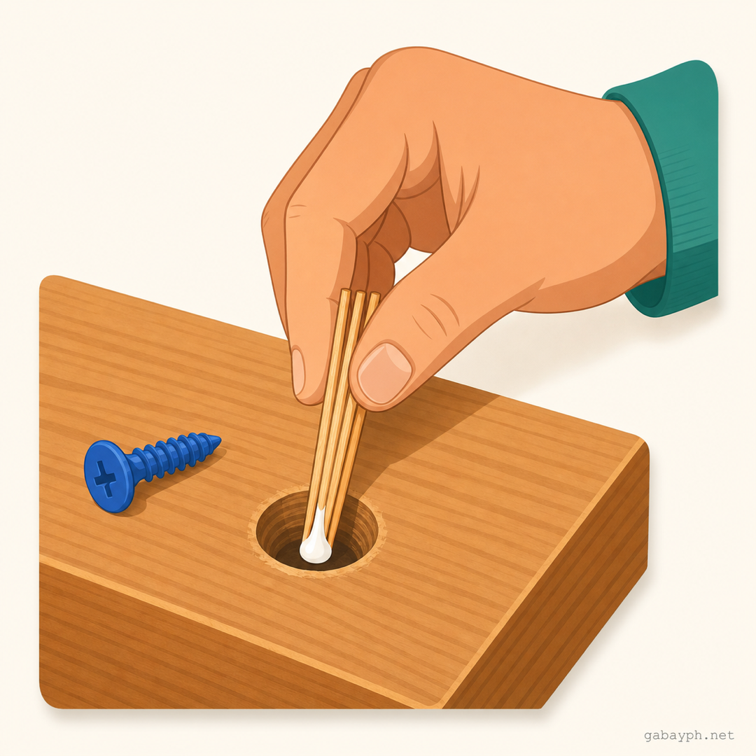 Hand inserting glue-tipped toothpicks into the empty screw hole