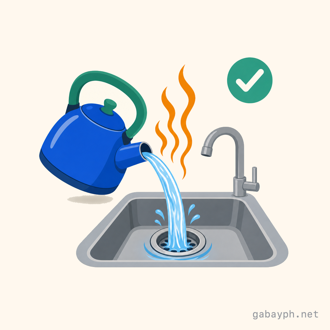 Kettle pouring steaming hot water into a clear drain