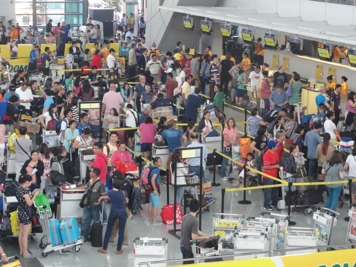 Crowded ticketing hall at NAIA Terminal 3, Manila — where many OFWs begin their journey abroad